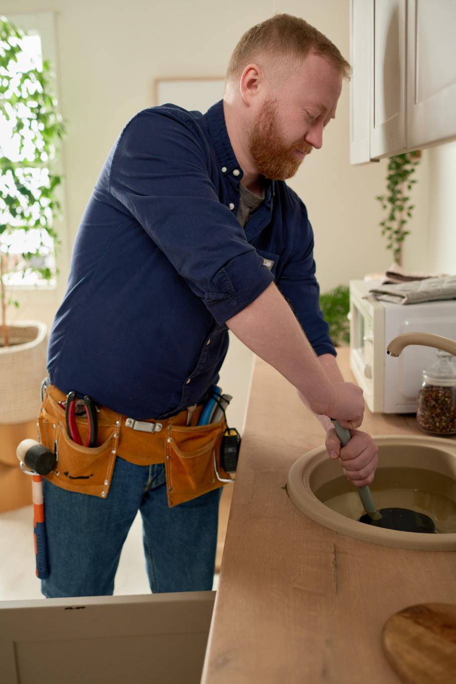 Professional plumber performing sink maintenance and repair
